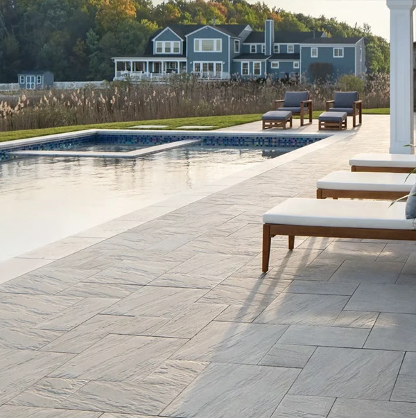 A picture of a pool deck using Techo-Bloc slabs which are larger pieces as compared to pavers