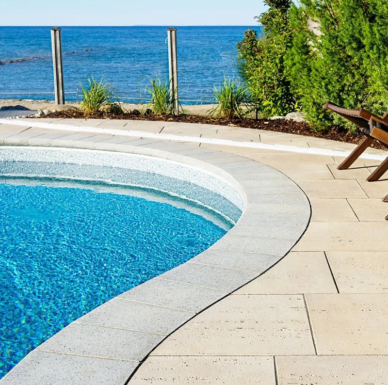 A picture of Techo-bloc-pool coping stones that also can be used as wall caps on concrete wall systems