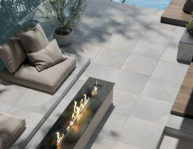 A patio and pool deck done in Indiana Limestone inspired porcelain pavers
