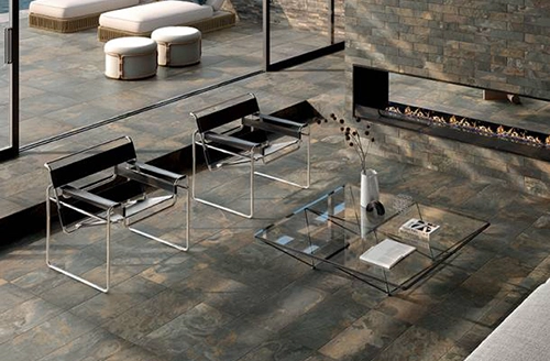 An image of a porcelain floor made up of indoor and outdoor tiles that resemble slate
